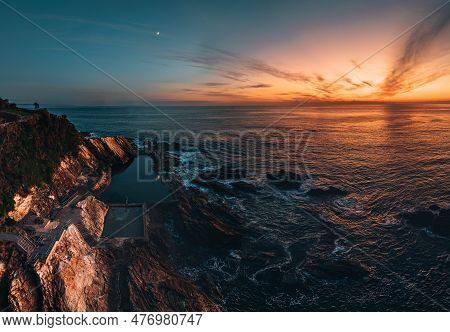 Blue Pool Rock Pool In Bermagui, New South Wales. Aerial Drone Shot During Sunrise With Wam Colors. 