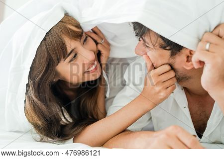 Happy Young Couple Relaxing At Home In The Morning.
