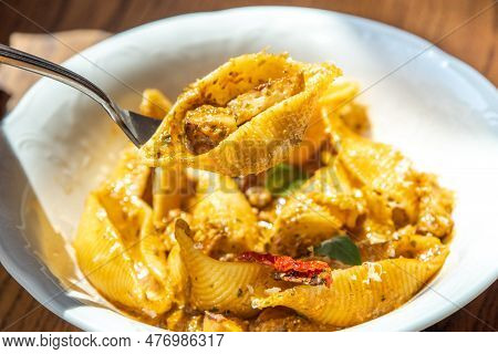 Close-up Photo Girl Eats Pasta At Restaurant