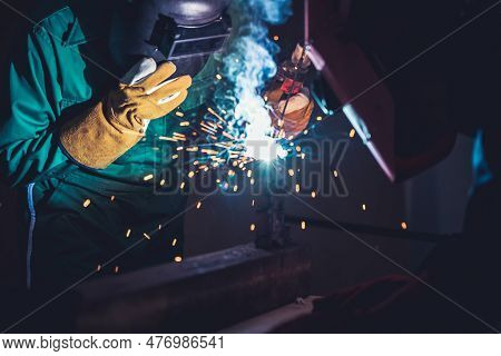 Metal Welding Steel Works Using Electric Arc Welding Machine To Weld Steel At Factory. Metalwork Man