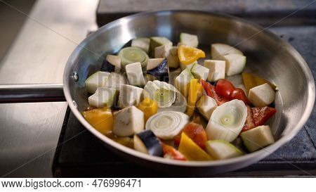 Vegetables Are Fried In A Pan. A Man Prepares Fresh Vegetables In A Frying Pan. Cooking Vegetables I