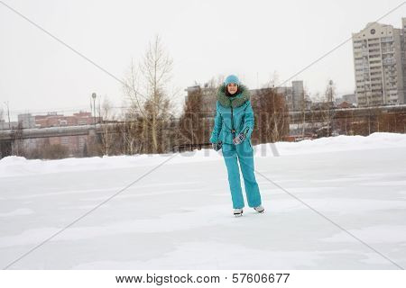 Young girl skating on the frozen lake