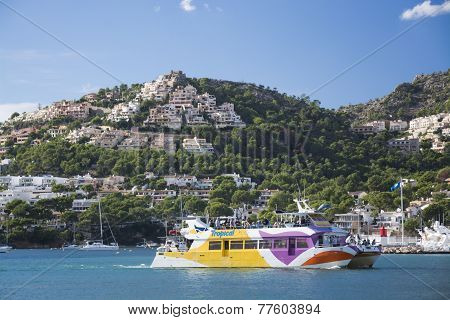 Tourist Glass Bottom Boat And Homes Perching On The Hills Above Port Andratx
