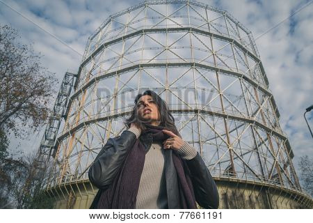 Beautiful Young Brunette Posing In Front Of A Gasometer
