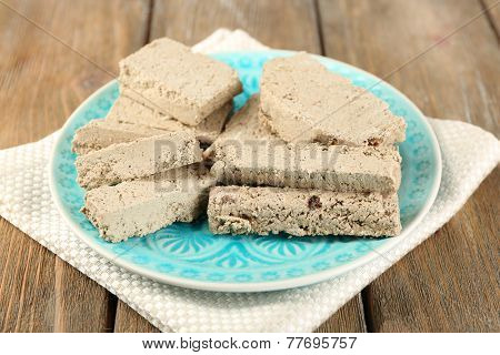 Two kinds of sunflower halva - with raisinas and vanilla taste. on plate, on wooden background