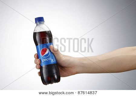 Kuala Lumpur,Malaysia 9th April 2015,Holding a can of Pepsi . Pepsi is a carbonated soft drink produced and manufactured by PepsiCo Inc. an American multinational food and beverage company.