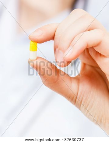 Nurse Holds Pilule In Finger