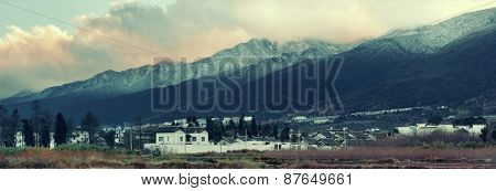 Dali old town rooftop view with snow capped Mt Cangshan. Yunnan, China.