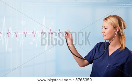 Pretty young medical doktor listening to red pulse and heart rates