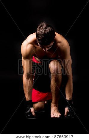 Portrait of boxer posing studio in gloves.