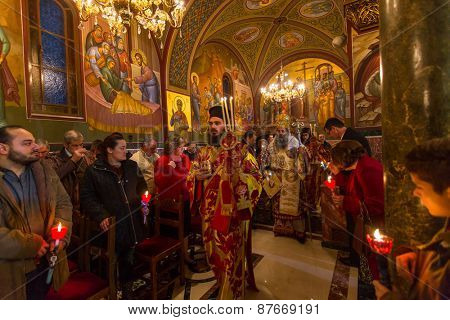 ATHENS, GREECE - APR 12, 2015: Unknown people during celebration of Orthodox Easter (Midnight Office of Pascha) Holy Saturday is often the only time that the Midnight Office will be read in parishes.