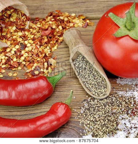 Tomato, Chili Pepper, Salt And Pepper On Rustic Wood Table
