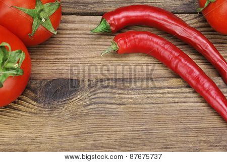 Two Fresh Red Hot Chili Peppers And Tomatoes