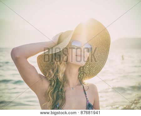 Young Blondy Girl In Sunglasses And Straw Hat At The Beach