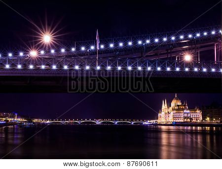 The Night View Of The Parlament Building And The Danube Under The Chain Bridge In Budapest