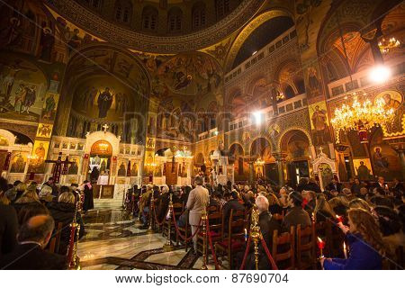 ATHENS, GREECE - APR 12, 2015: Unknown people during celebration of Orthodox Easter (Midnight Office of Pascha) Holy Saturday is often the only time that the Midnight Office will be read in parishes.