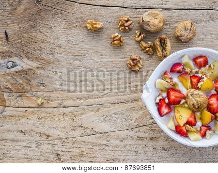 A Bowl Of Fruit, Walnuts And Yogurt