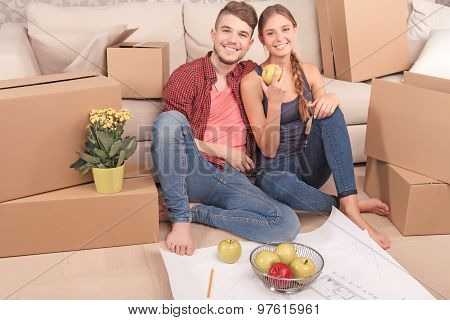 Pleasant young couple holding apples
