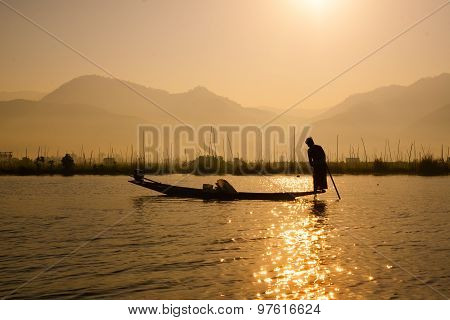 Three fishermen catches fish for food in sunrise in Inle Lake, Myanmar