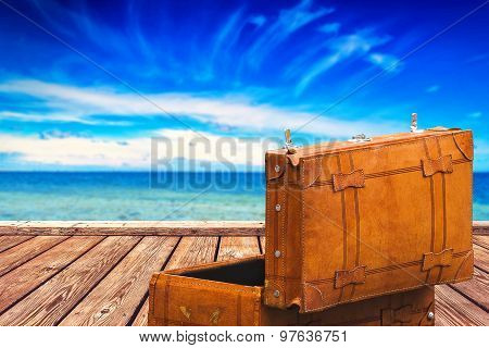 Vintage Suitcase At Boardwalk And Open Sea