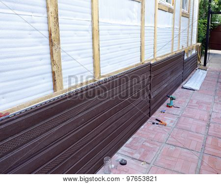 Installation Of Brown Plastic Siding On The Facade