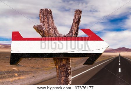 Yemen Flag wooden sign with desert road background