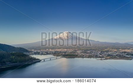 Mountain Fuji reflected in Kawaguchiko lake on a sunny day and clear sky, Yamanashi Japan