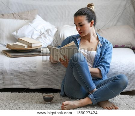 Girl Reading A Book In A Cozy Room