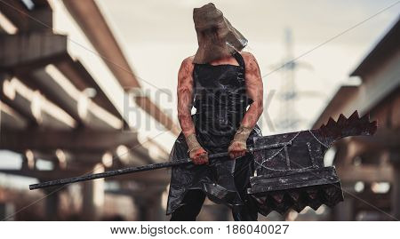 Mutant monster with weapon in form of hammer saw and an ax. Imagination. Mutant with sack on his head.