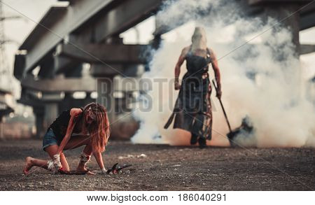Battle of two mutants. Mutant with hammer goes to girl mutant through smoke.