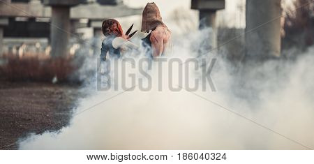 Battle of two mutants. They fight through smoke.