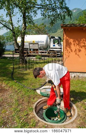 Worker Making Gas Supply On A Tank In The Garden