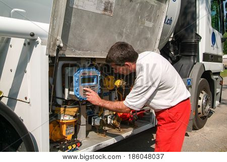 Worker Making Gas Supply On A Tank In The Garden