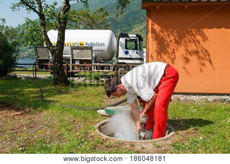 Worker Making Gas Supply On A Tank In The Garden