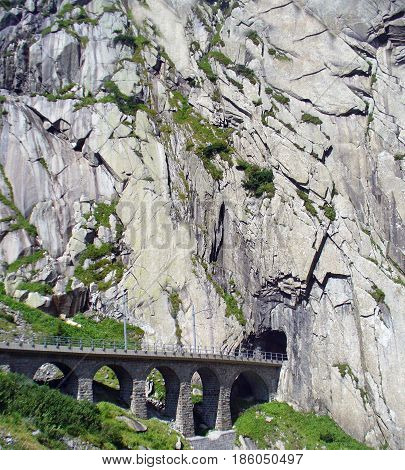Railway bridge and tunnel in Switzerland near village Andermatt.