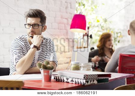 Hipster Student Working In Industrial Cafe