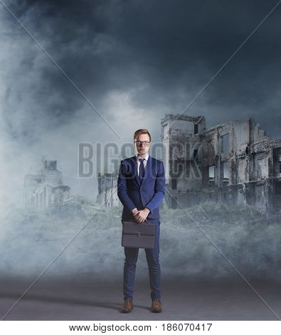 Businessman standing on apocalyptic background. Crisis, default, setback concept.