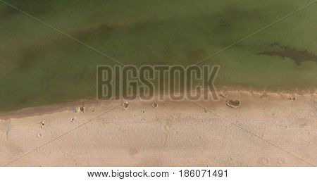Aerial view of Baltic sea shore, waves and sandy beach. Lubiatowo, Poland