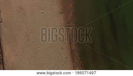 Aerial view of Baltic sea shore, waves and sandy beach. Lubiatowo, Poland