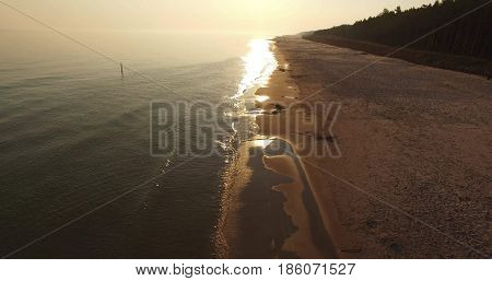 Sunrise of sun setting over Baltic sea on calm morning. Aerial shoot. Lubiatowo, Poland.