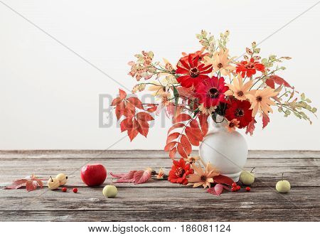 Still life with a autumn flowers and leaves