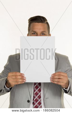manager holding blank sheet in front of face