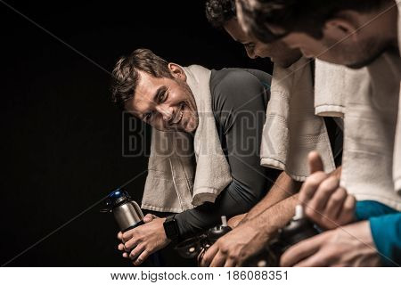 Handsome Young Athletes Resting At Gym Locker Room