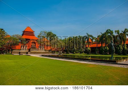 Beautiful Balinese Building With A Fountain And Sculpture-man Playing The Flute. Tanjung Benoa. Nusa