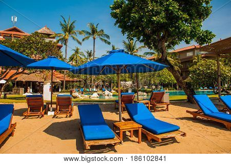 Sun Loungers And Parasols On The Beach. Bali, Indonesia, Tanjung Benoa. Nusa Dua.