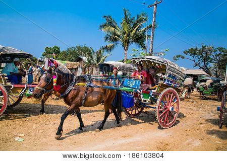 INNWA, MYANMAR-MARCH 6, 2017: Burmaneses tourists tour at horse drawn carriage in Innwa on March 6, 2017, Mandaley. Myanmar. (Burma)