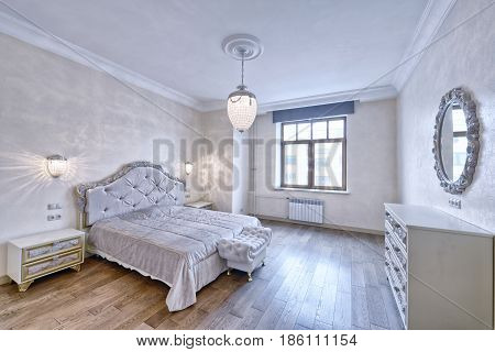 Russia, Moscow - modern designer renovation in a luxury building. Stylish bedroom interior with double bed.