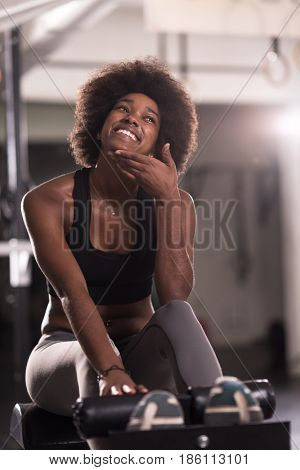 young fit african american woman doing sit ups in fitness studio at the gym.Abdominal exercises Sit up