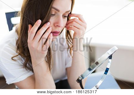 Woman Sitting By The Mirror