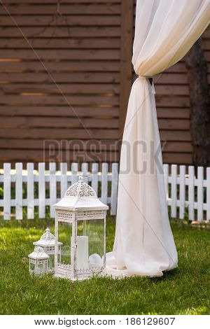 Beautiful Wedding Ceremony Outdoors. Decorated Chairs Stand On The Grass. Wedding Arch Made  Flowers